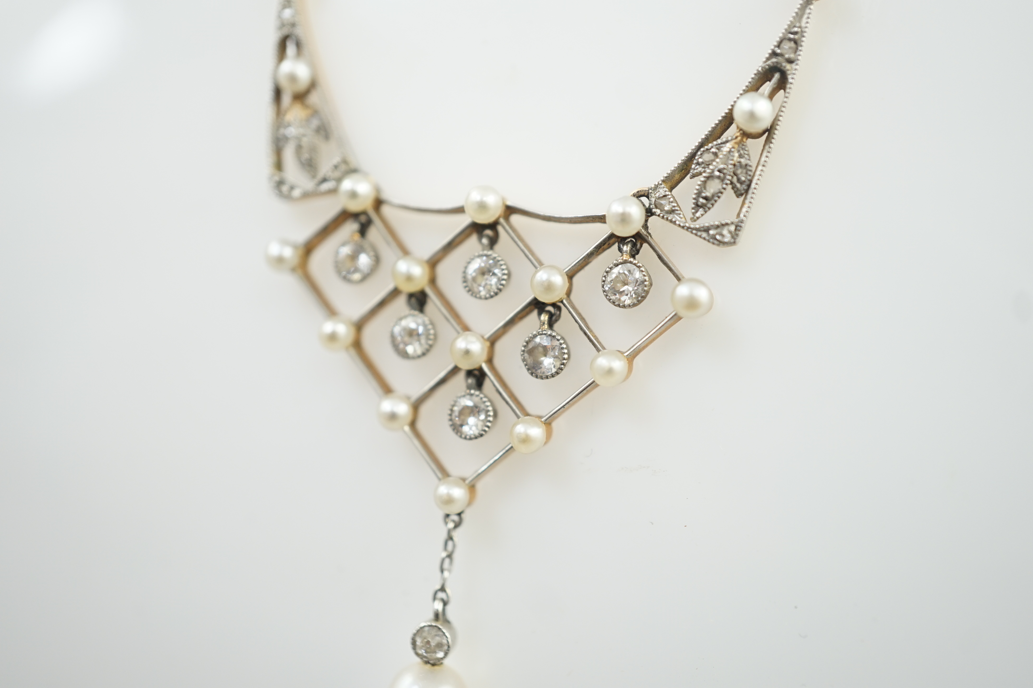 An early 20th century gold and platinum, diamond and seed pearl cluster set drop pendant necklace